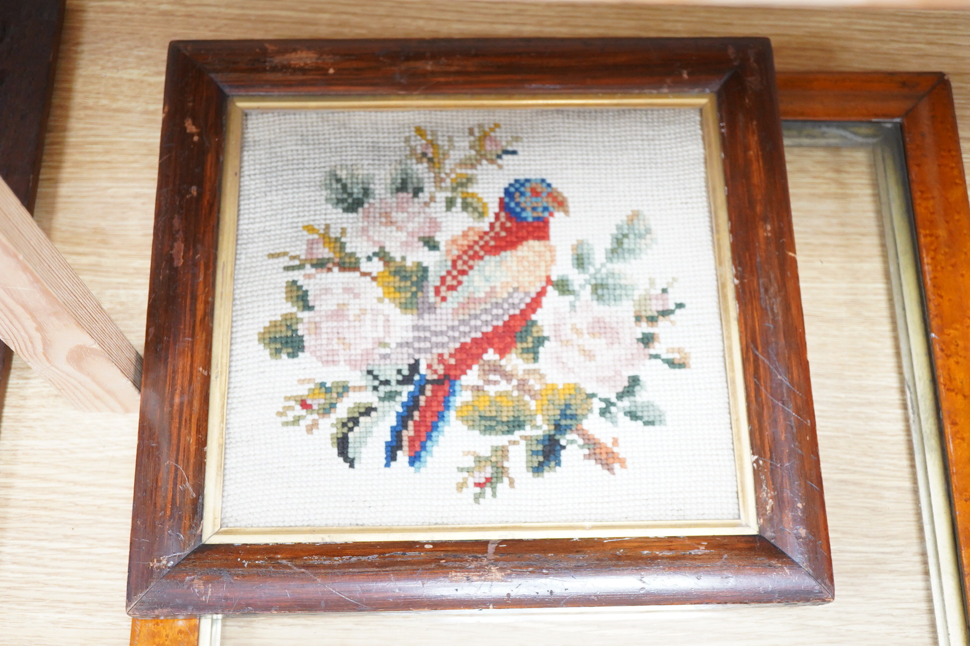 A framed 19th century woolwork embroidery of a bird, a floral wool bell pull with gilt mounts and a large maple frame
